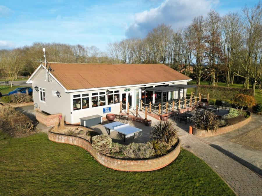 reception and outside seating at Cakes and Ale Holiday Park