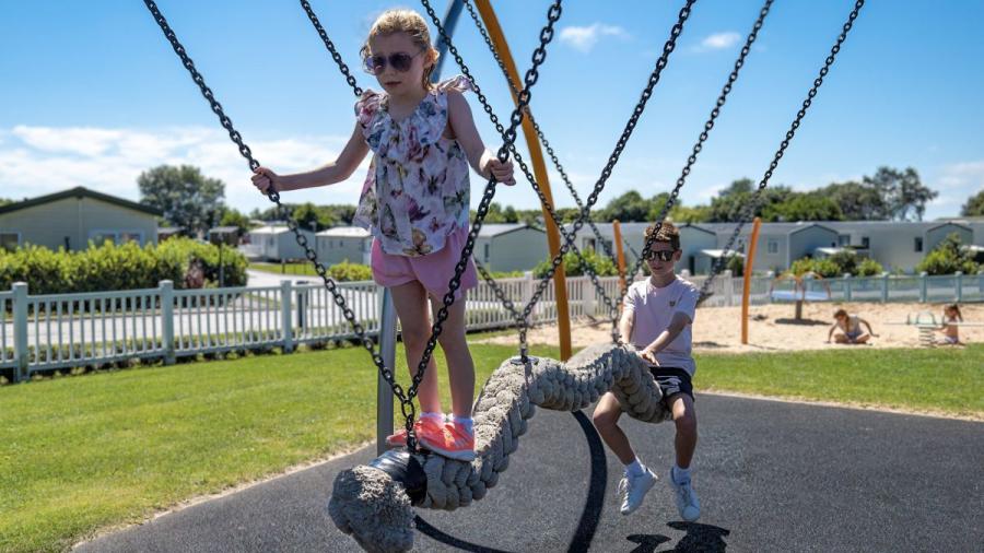 children playign in the adventure playground at Riverside Holiday Park