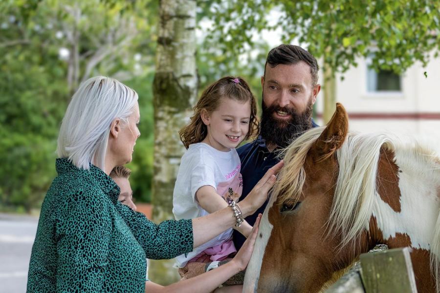 petting the on-site horses at Royal Umpire Holiday Park