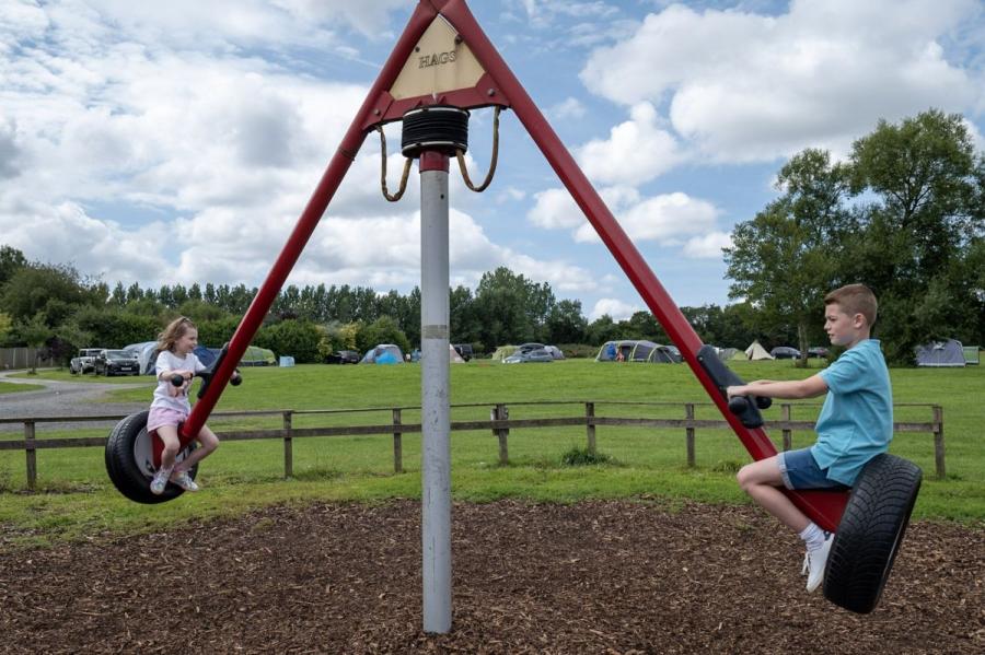 children on the swings on holiday at Royal Umpire Holiday Park