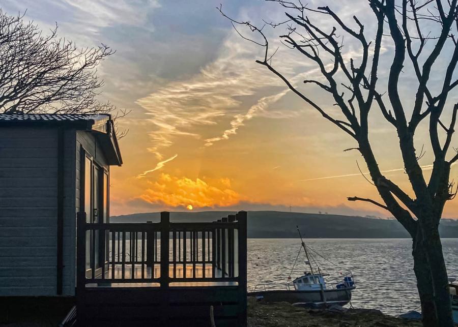 caravan with decking at waters edge leisure park in cardigan