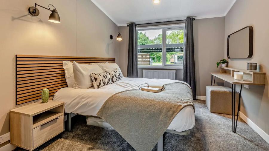 main bedroom in a luxury lodge at Bryn Morfydd Lodge Park