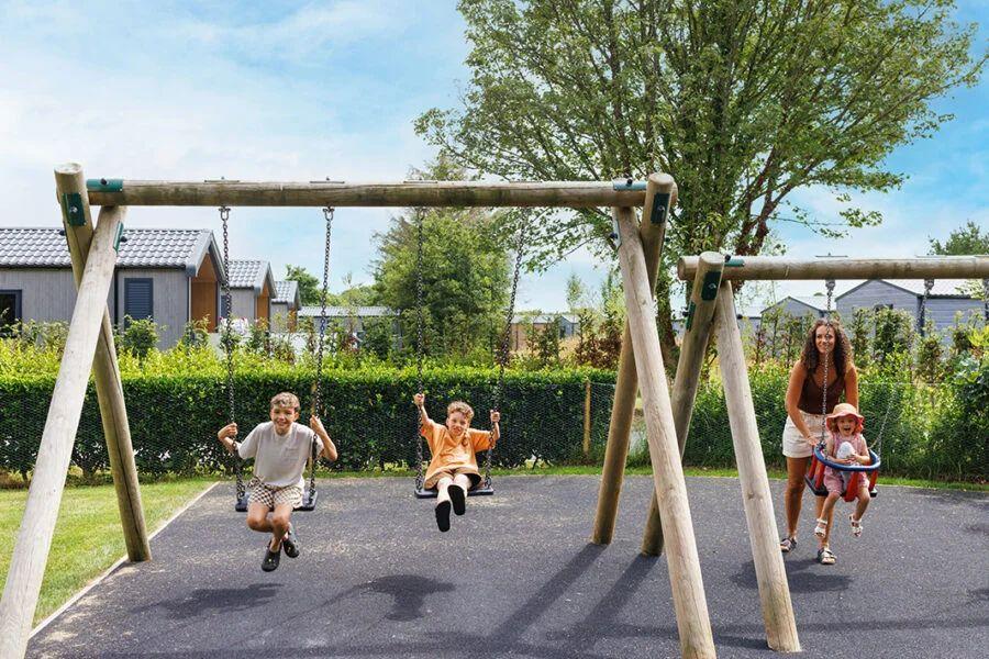 the swings in the playground at Cornish Meadows Holiday Park
