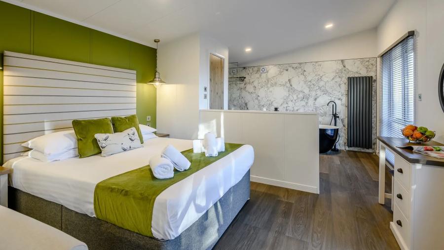 double bedroom in a luxury lodge at Kenwick Woods Lodge Resort