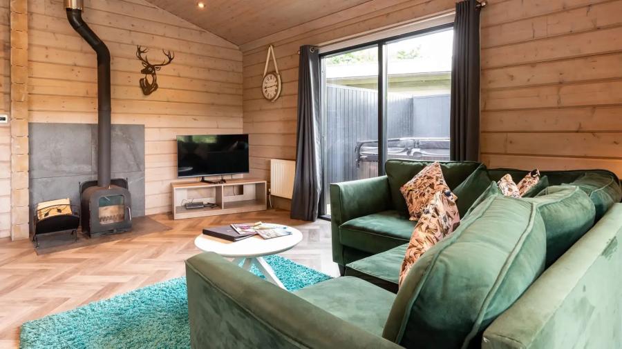 inside a lodge with a fire at Aysgarth Holiday Resort