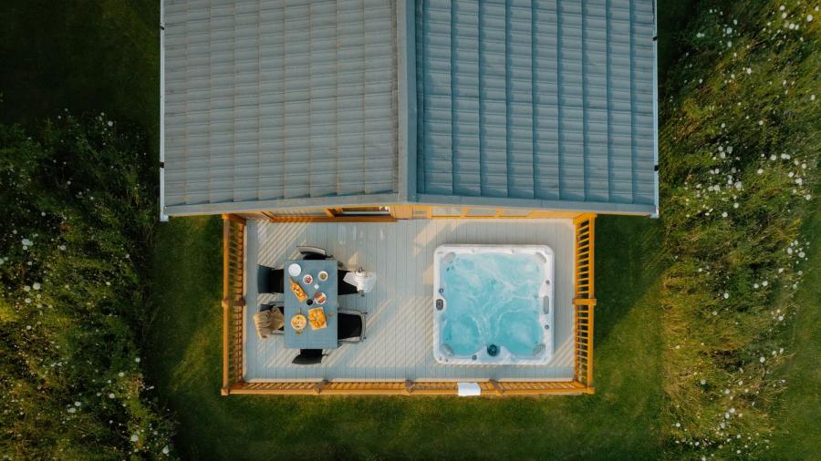 view over a lodge with a hot tub at Rockingham Forest Holiday Park