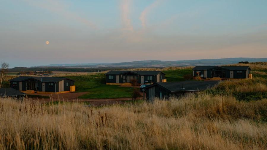 Whitekirk Hill Resort lodges at sunset