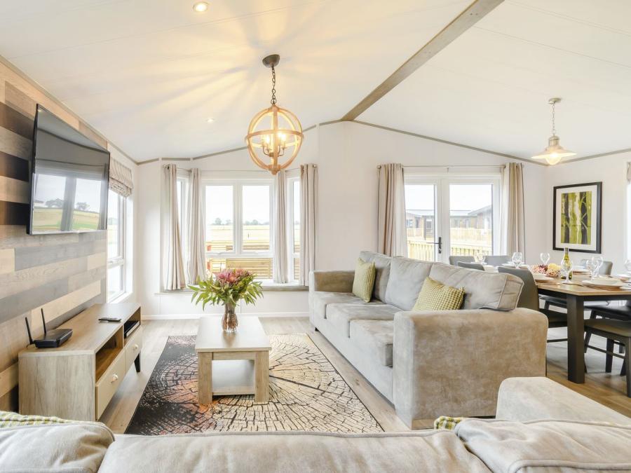 open plan living space in a lodge at Woodland Lakes Holiday Resort